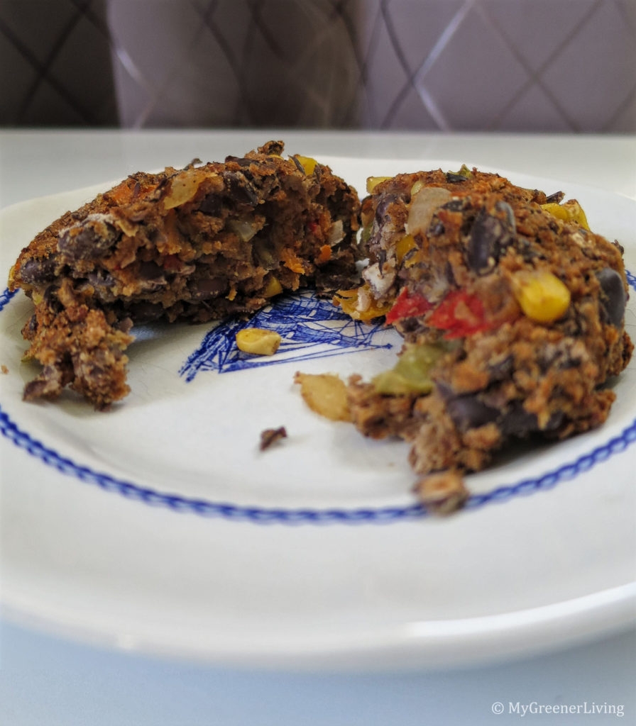 cooked veggie bean burger but in half on a plate