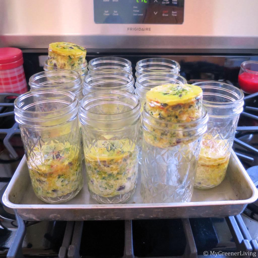 baked eggs and veggies in mason jars. steam caused some eggs to rise up in the jars